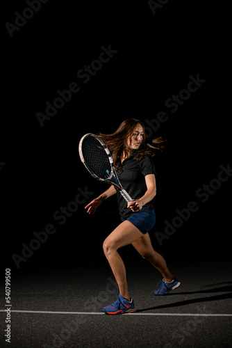 athletic woman player with tennis racket at tennis court.