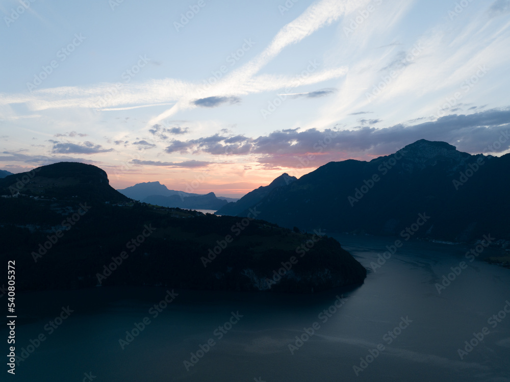 Vierwaldstattersee, Schwyz, located in Inner Switzerland, Aerial drone view of alpine lake road forrest and mountains. Turqoise water and environment overview.