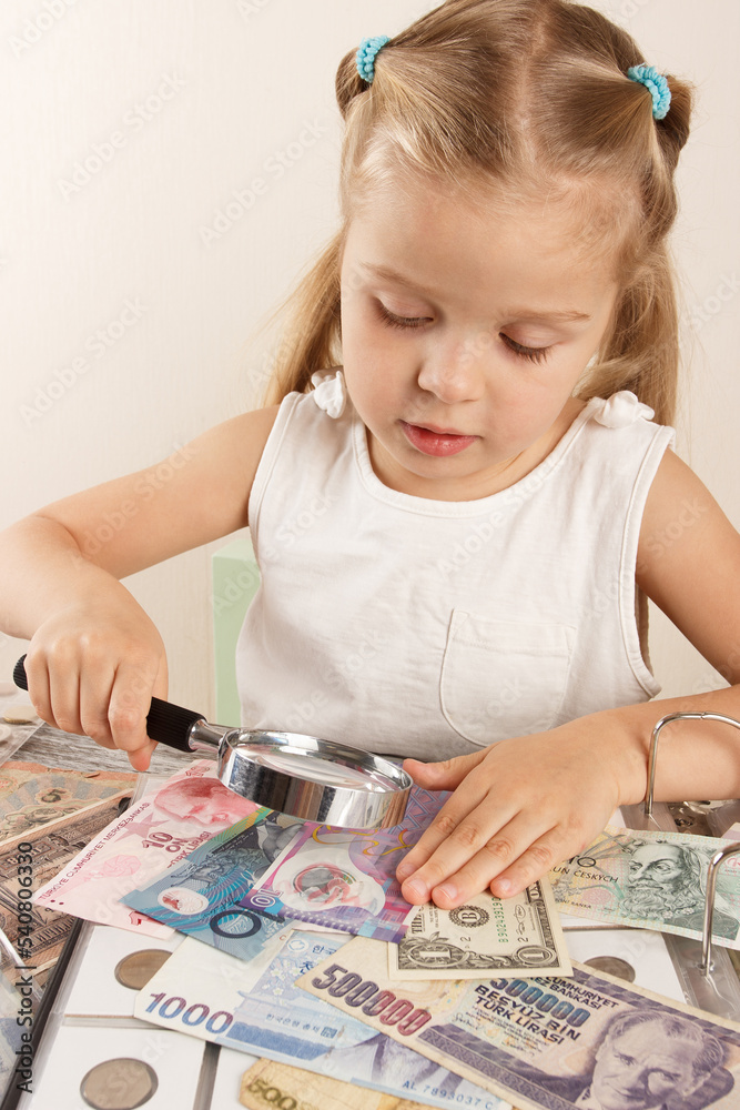 Child with different coins and banknotes