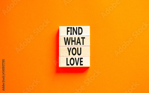 Find what you love symbol. Concept words Find what you love on wooden blocks. Beautiful orange table orange background. Business, psychological find what you love concept. Copy space.