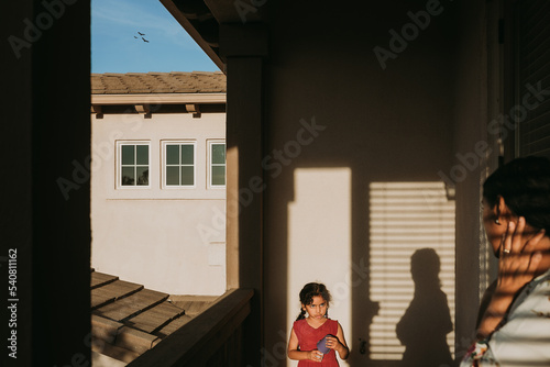 Little kid Playing with shadows in the balcony 