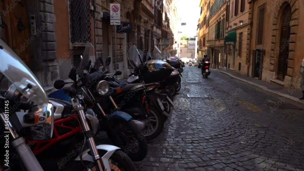 Roma, Italy- may 2014: Parking of motorcycles on a narrow street of old Rome. Dolly camera shot. Roma, Italy- may 2014: Parking of motorcycles on a narrow street of old Rome. Dolly camera shot.