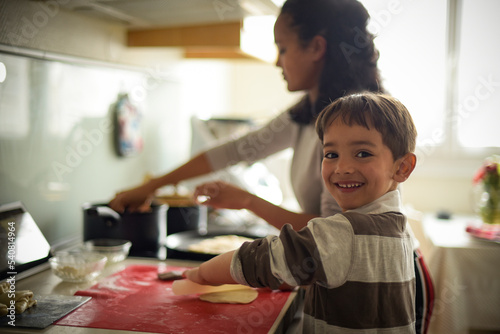 young boy learning cooking at home