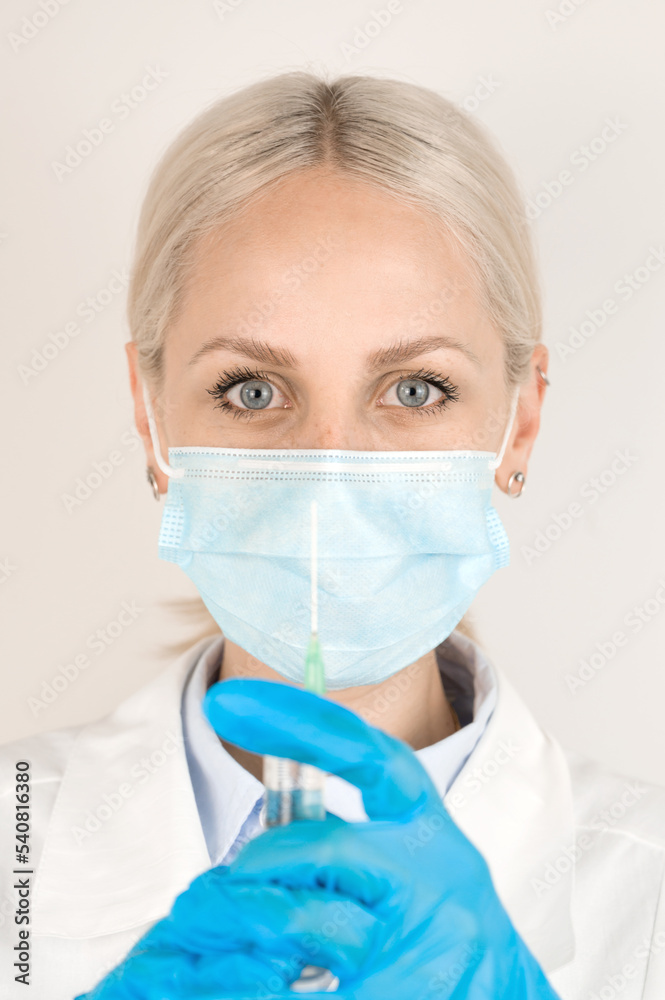 Vertical banner with medical worker wearing mask holding syringe.Vaccination concept. Vertical banner with medical worker wearing mask holding syringe.Vaccination concept.