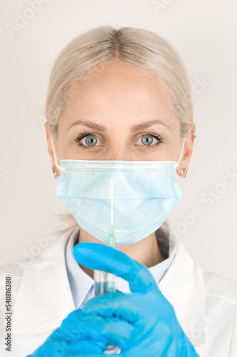 Vertical banner with medical worker wearing mask holding syringe.Vaccination concept.
