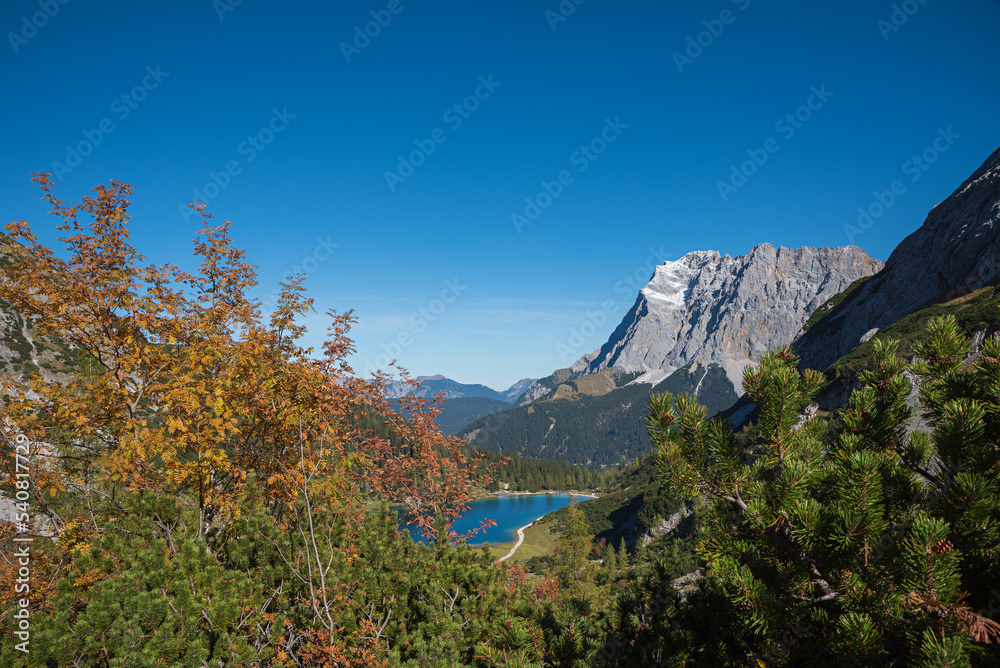 autumn landscape Tirol, lake Seebensee and Zugspitze mountain, view from the hiking trail