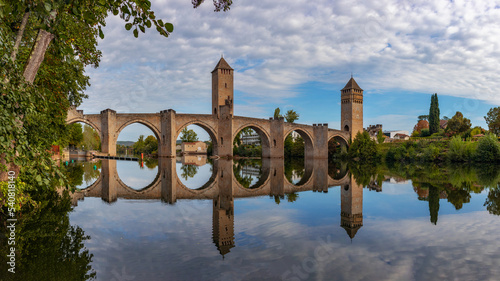 The Valentre Bridge is a 14th-century stone arched bridge over the River Lot in Cahors. Fortified with three towers with hinged loopholes, it is a bridge-fortress.