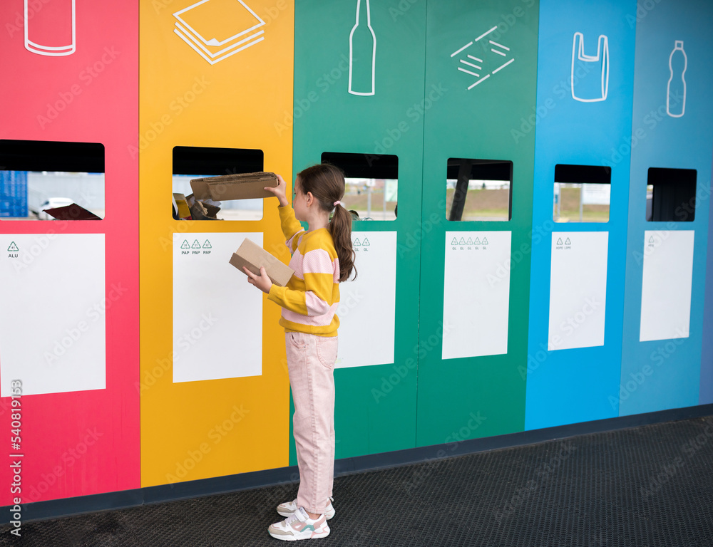 Girl dumping cardboard in bank for reduce, reuse, recycle. National