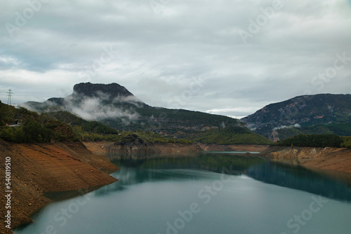 Nearly dry reservoir in autumn, October 2022. Effects of climate change such as desertification and droughts. In the Pyrenees of Catalonia, Spain.