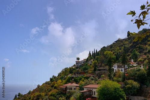 mountainside with houses on it against the blue sky. High quality photo photo