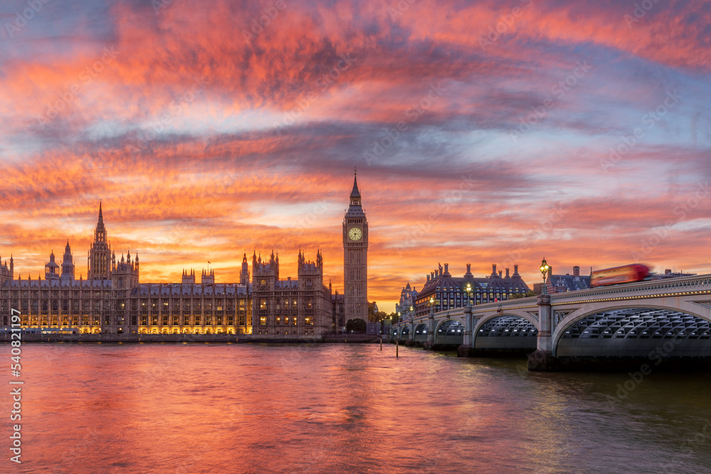 Houses of parliament next to Big Ben in London, England during a very colorful sunset