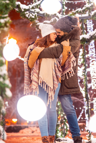 Couple hugging at Christmas market © Impact Photography