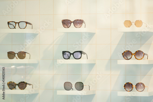 Exhibitor of glasses consisting of shelves of fashionable glasses shown at the optical shop photo