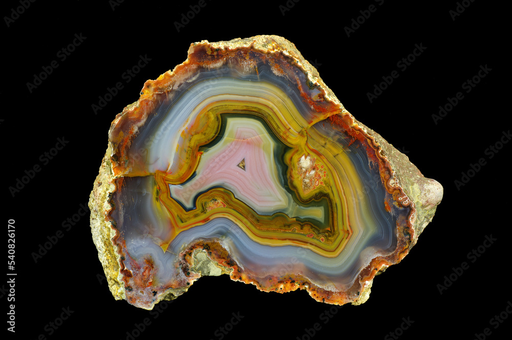 A cross section of the agate stone. Multicolored agate with a unique contrasting pattern and pseudomorphosis. Origin: Morocco, High Atlas area around Aquim. A cross section of the agate stone. Multicolored agate with a unique contrasting pattern and pseudomorphosis. Origin: Morocco, High Atlas area around Aquim.