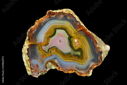 A cross section of the agate stone. Multicolored agate with a unique contrasting pattern and pseudomorphosis. Origin: Morocco, High Atlas area around Aquim.