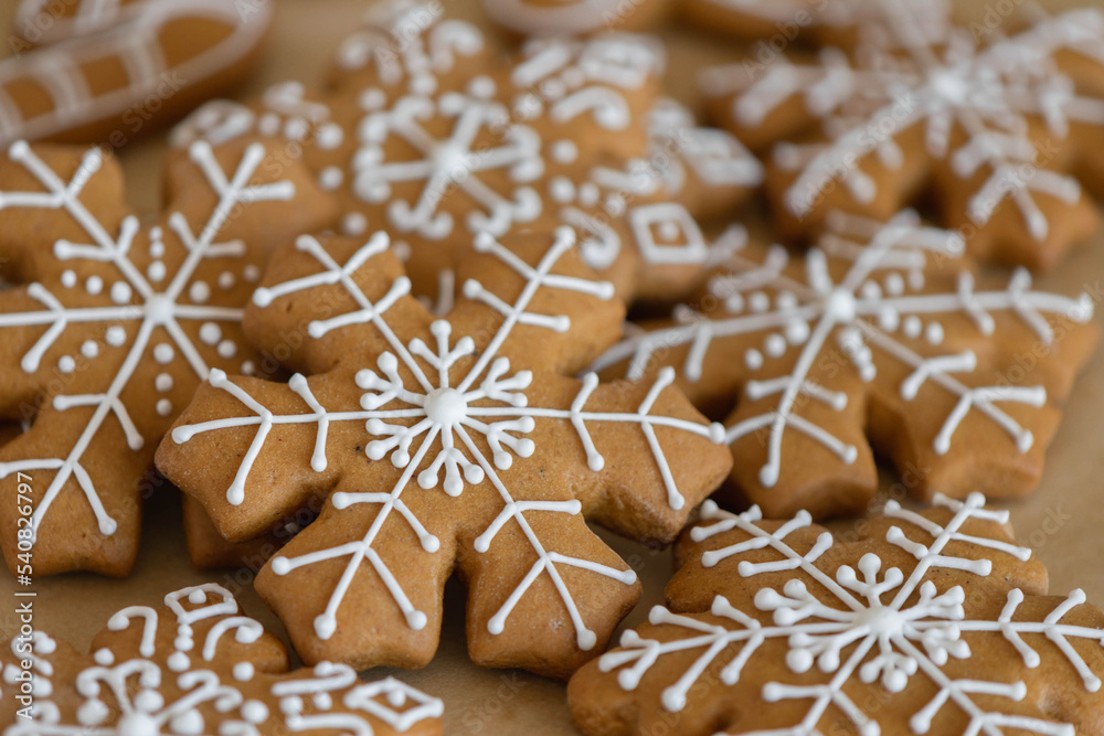 New Year's traditional gingerbread cookies decorated with sugar white icing close-up New Year's traditional gingerbread cookies decorated with sugar white icing close-up