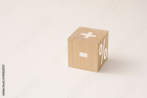 sign plus, minus, percent drawn on wooden block over white background with copy space.