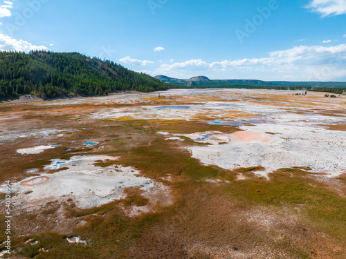 Beautiful geysers with hot water and steam with pools of thermophilic bacteria in the Upper Geyser Basin of Yellowstone National Park  Wyoming  United States.