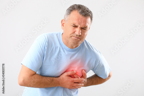 Mature man having heart att...