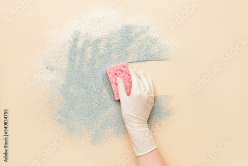 Woman in medical glove wipi...