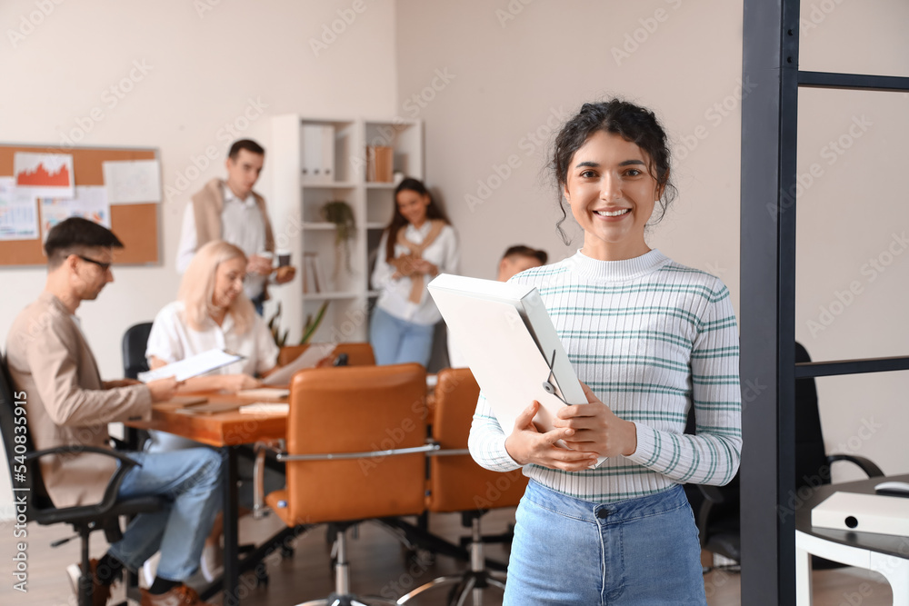Fototapeta premium Beautiful businesswoman with folder working in office