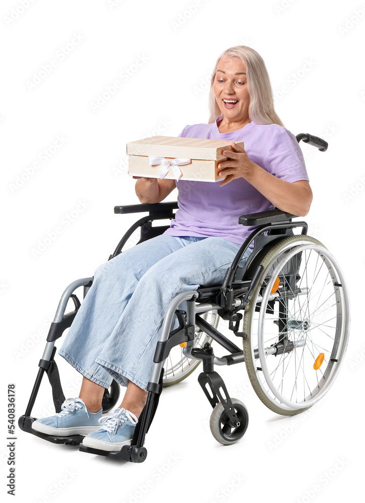 Mature woman in wheelchair and with gift isolated on white Mature woman in wheelchair and with gift isolated on white
