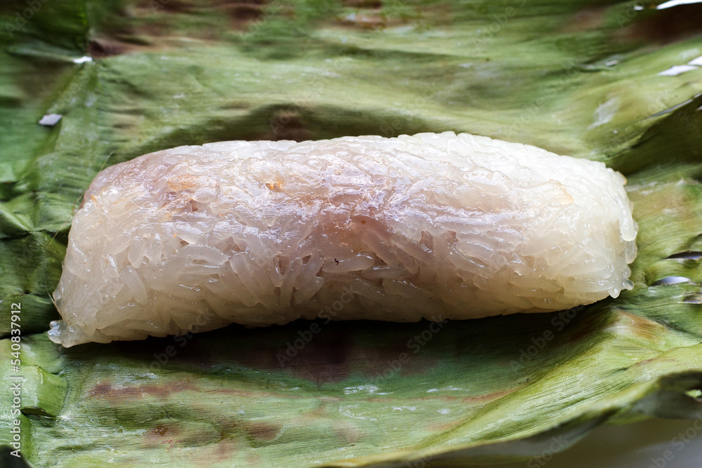 Grilled sticky rice in banana leaves with banana filling Grilled sticky rice in banana leaves with banana filling