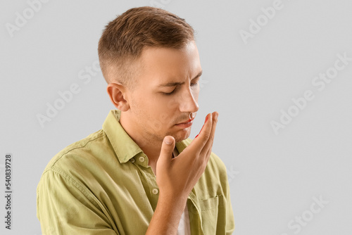 Young man with nosebleed on...