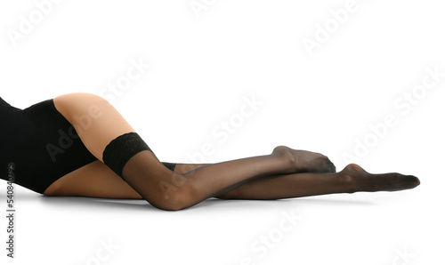 Legs of beautiful young woman in black stockings on white background