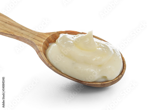 Wooden spoon of tasty vanilla pudding on white background, closeup