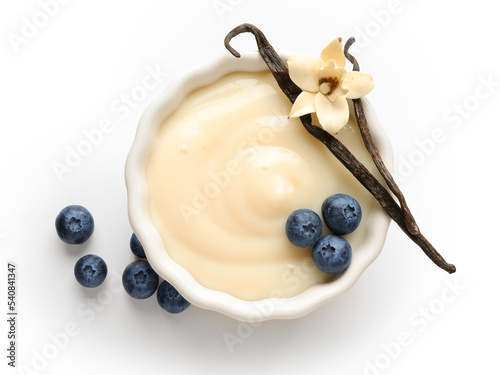 Fotografie Ramekin of delicious vanilla pudding with blueberry on white background