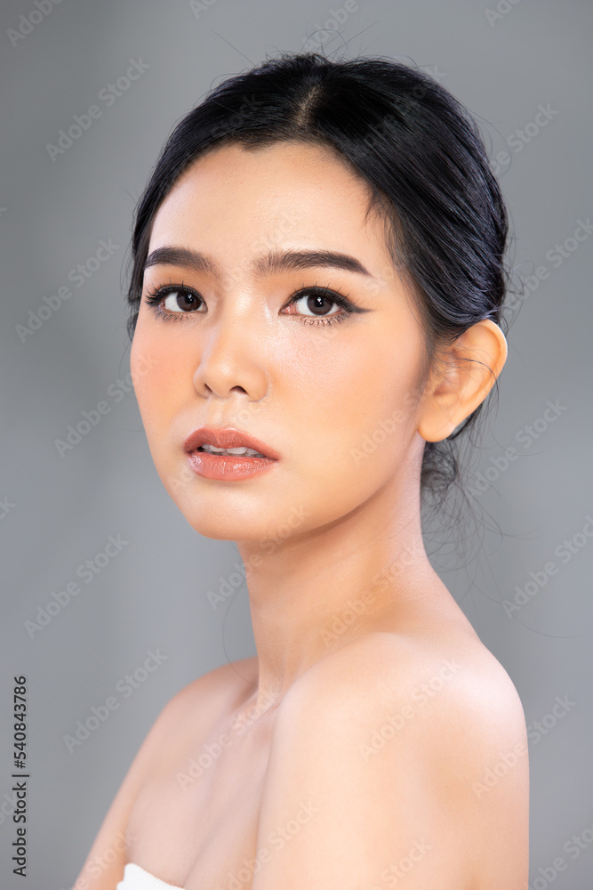 Portrait Face shot Beautiful young Asian woman with fashion cosmetic make up clean skin on gray background isolated. Face care, elegance Cosmetology, beauty love female Portrait Face shot Beautiful young Asian woman with fashion cosmetic make up clean skin on gray background isolated. Face care, elegance Cosmetology, beauty love female