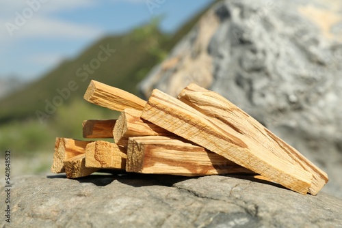 Many palo santo sticks on stone surface in high mountains, closeup
