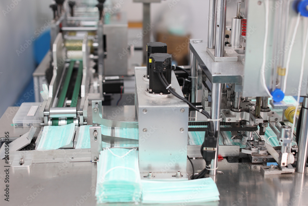 Industry and factory concept, medical face mask production line.