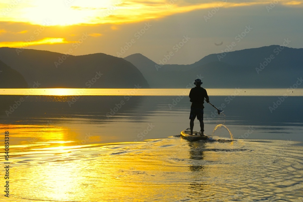 silhouette of a person on a sup