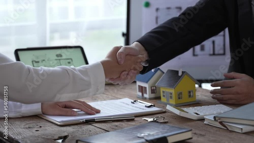 Estate agent are presenting home loan to client and discussing to decision signing agreement contract form, Home Insurance and Real estate investment concept. photo