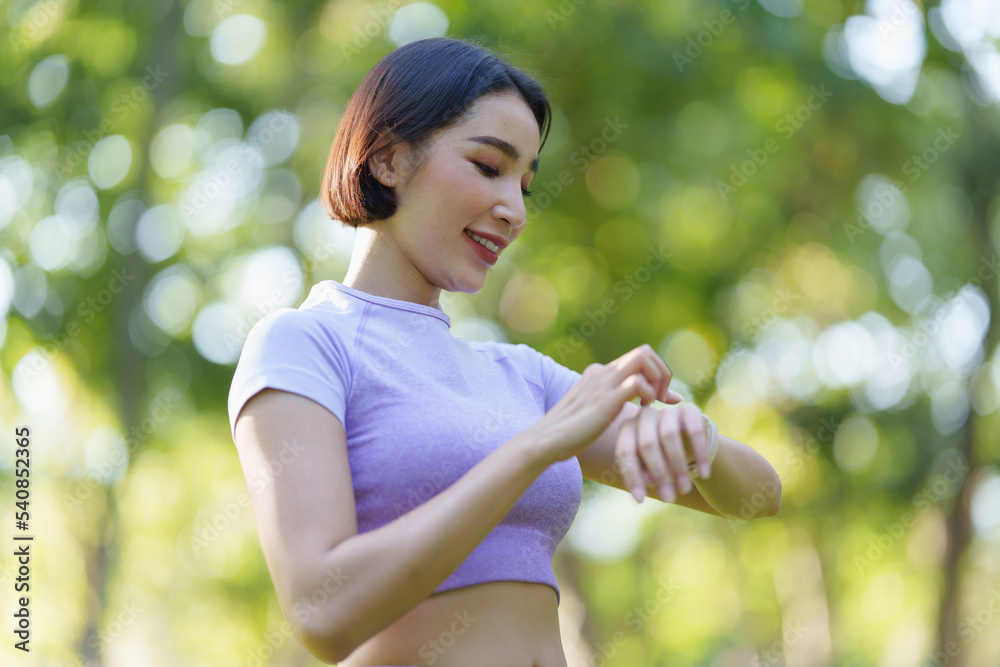Attractive Asian woman in sportswear practicing yoga in the outdoor park Attractive Asian woman in sportswear practicing yoga in the outdoor park