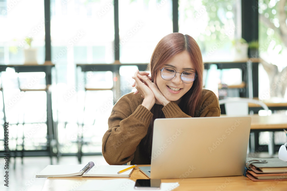 Young woman studying or working online using laptop. Young woman studying or working online using laptop.