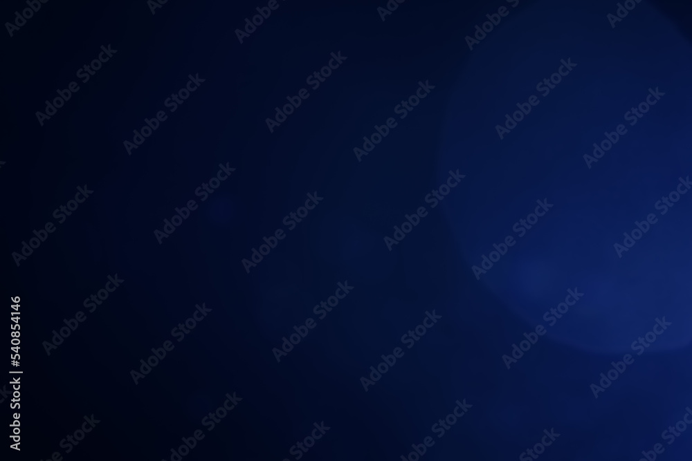 A dark blue background bokeh image for used to decorate background.