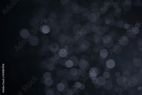 A dark blue background bokeh image for used to decorate background.