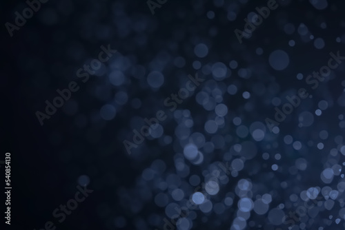 A dark blue background bokeh image for used to decorate background.