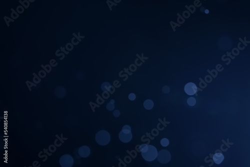 A dark blue background bokeh image for used to decorate background.