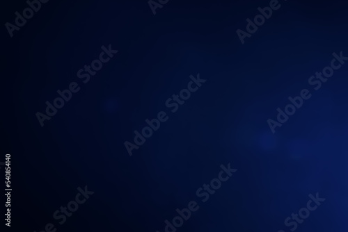 A dark blue background bokeh image for used to decorate background.