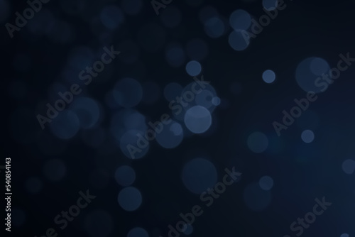 A dark blue background bokeh image for used to decorate background.