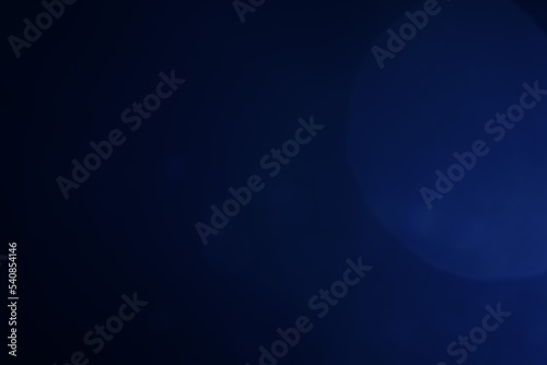 A dark blue background bokeh image for used to decorate background.