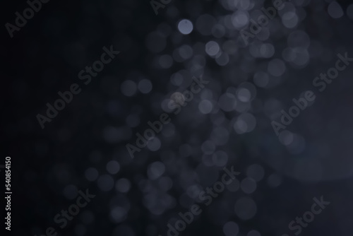 A dark blue background bokeh image for used to decorate background.