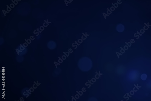 A dark blue background bokeh image for used to decorate background.