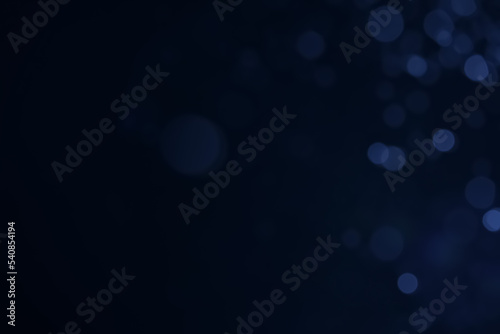 A dark blue background bokeh image for used to decorate background.