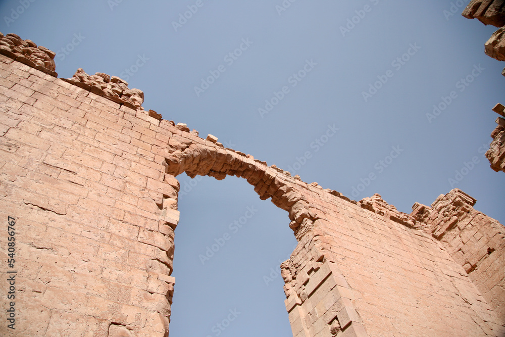 Petra, Jordan, November 2019 - A large tall tower with a clock at the top of a rock Petra, Jordan, November 2019 - A large tall tower with a clock at the top of a rock