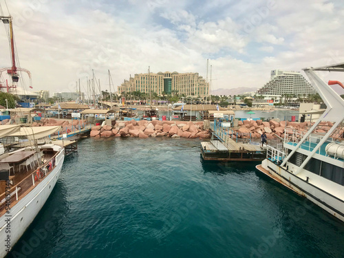 Eilat, Israel, November 2019 - A boat is docked next to a body of water © Alex Adventurer